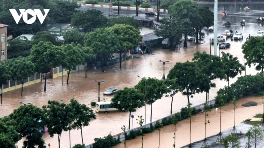 Hanoi streets turn into rivers after heavy downpours
