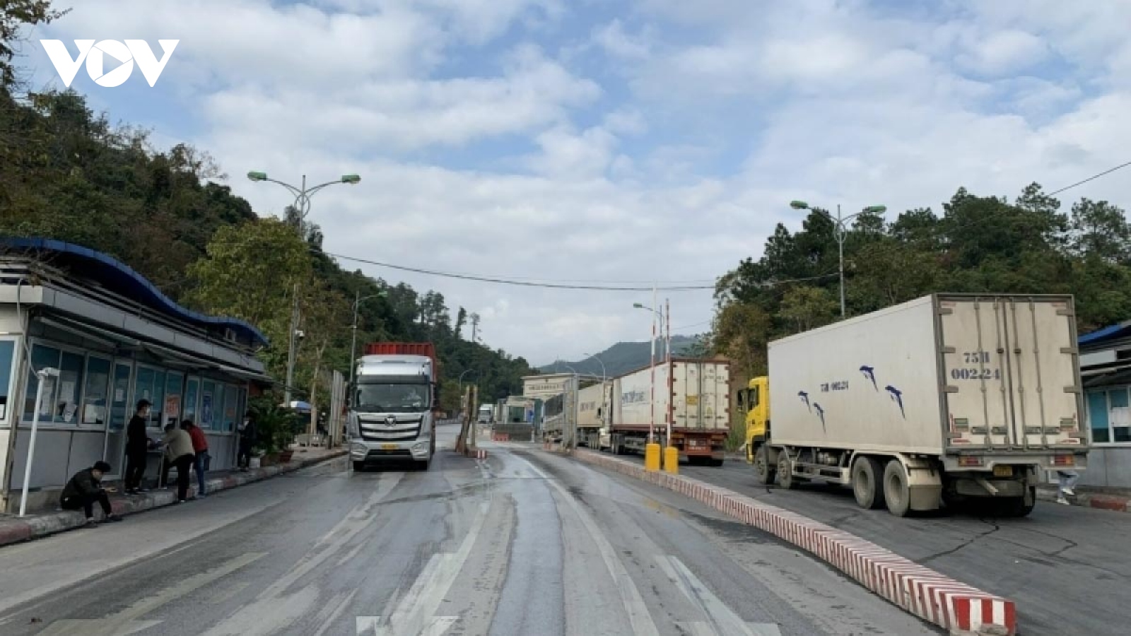 More container trucks cross border gates into China