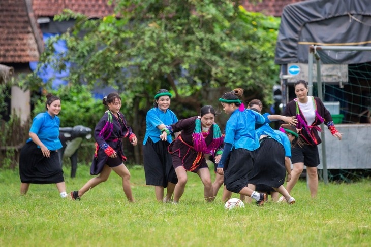 Ethnic women in skirts play football in mountainous market